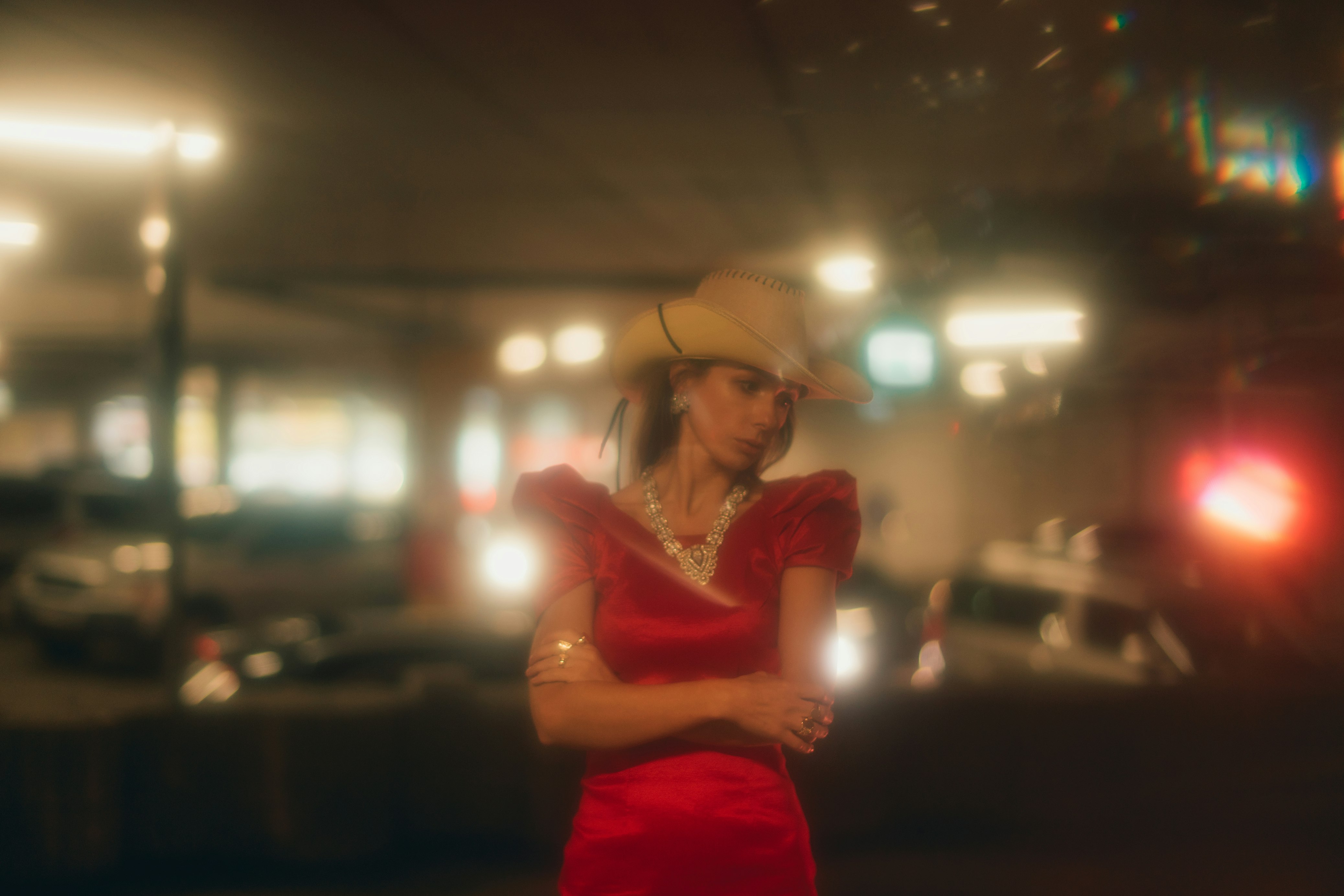 woman wears red dress and brown cowboy hat
